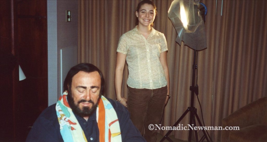 Intern poses behind Pavarotti